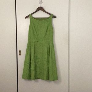 Bright green midi dress with wooden patten and pleated skirt